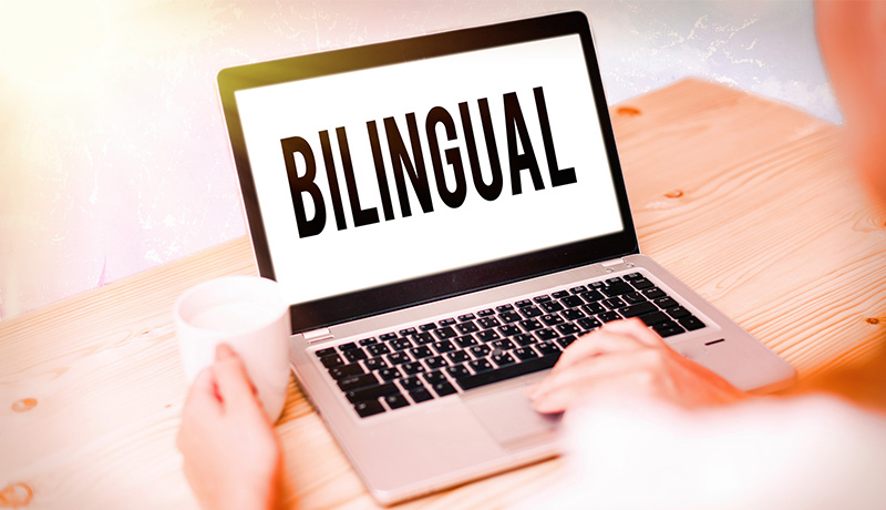Home 4 Laptop screen displaying "Bilingual" text representing English and Spanish service