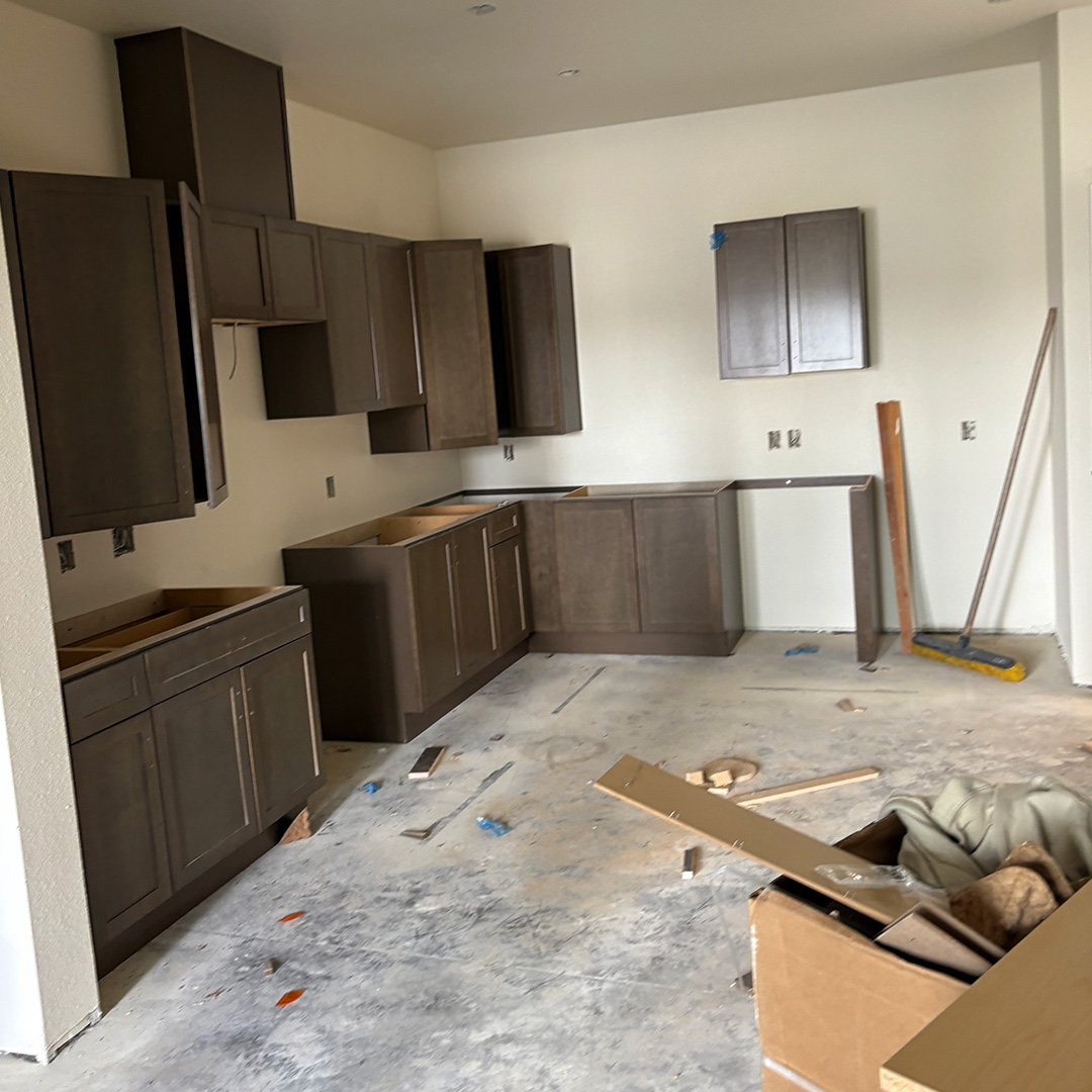 post_construction_lolas-shiny-1 Kitchen under construction with unfinished cabinets and debris before post-construction cleaning