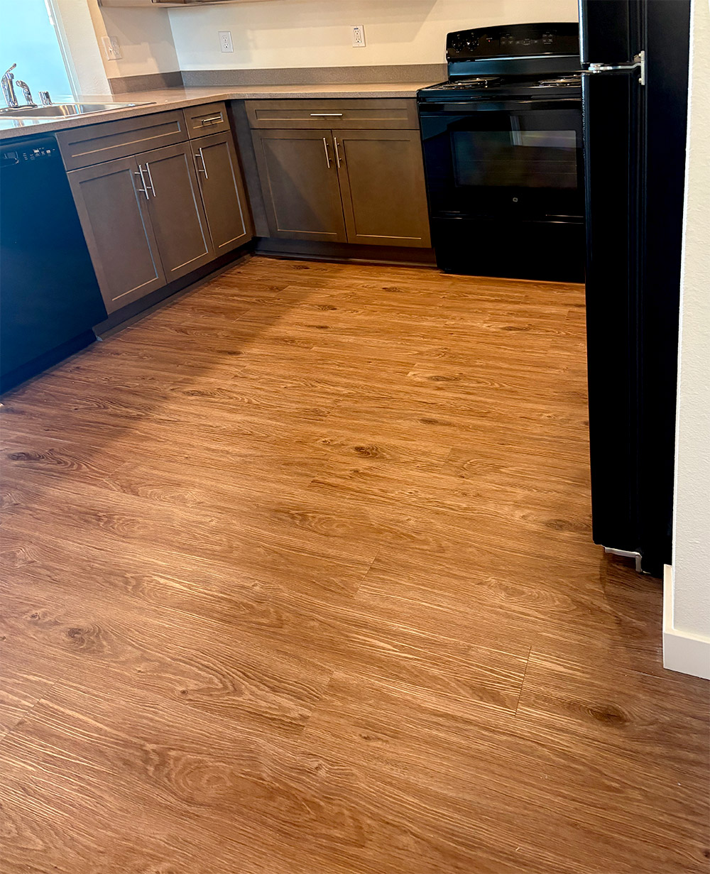 Clean kitchen with wood floor after residential cleaning service 